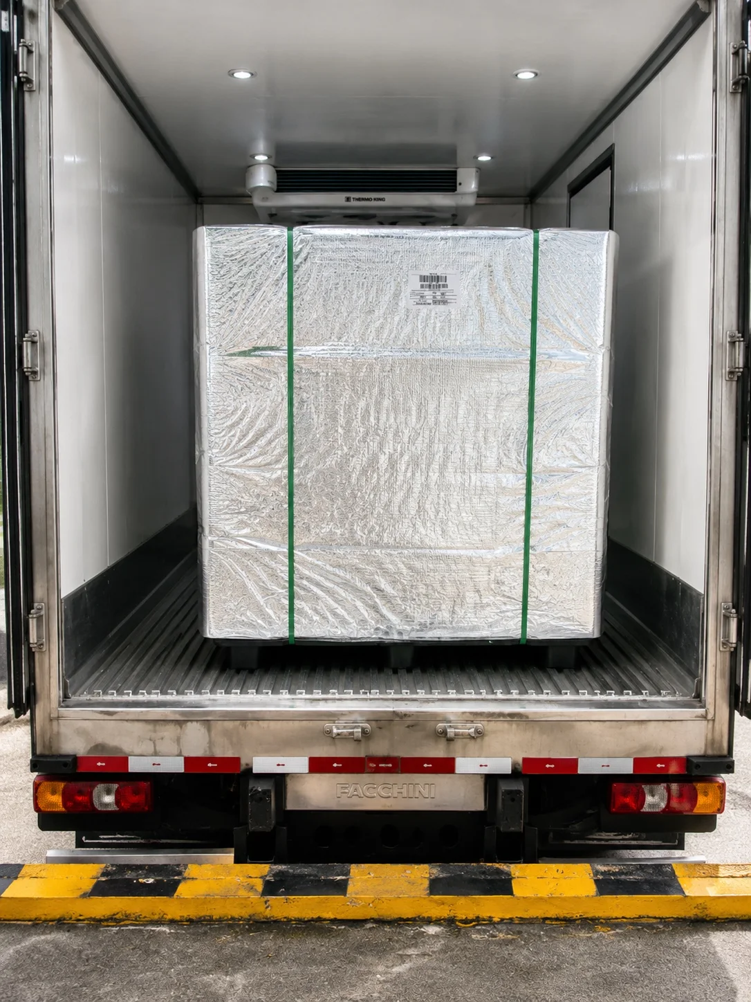 Palletized chilled seafood inside a refrigerated delivery truck